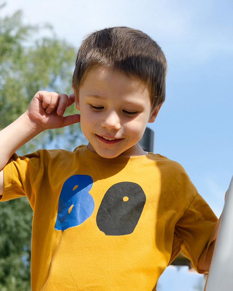 Boy standing on top of a UniMix unit, looking down.